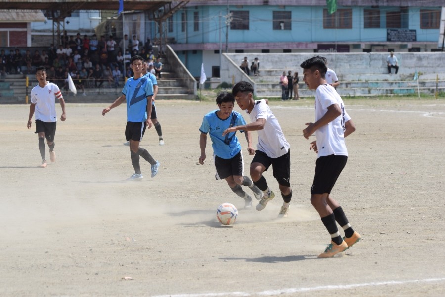 Players of Arkong Ward in White jersey and Mongsebbai (Blue) in action during the first match of the 4th Mokokchung Inter-ward Football tournament on April 10.