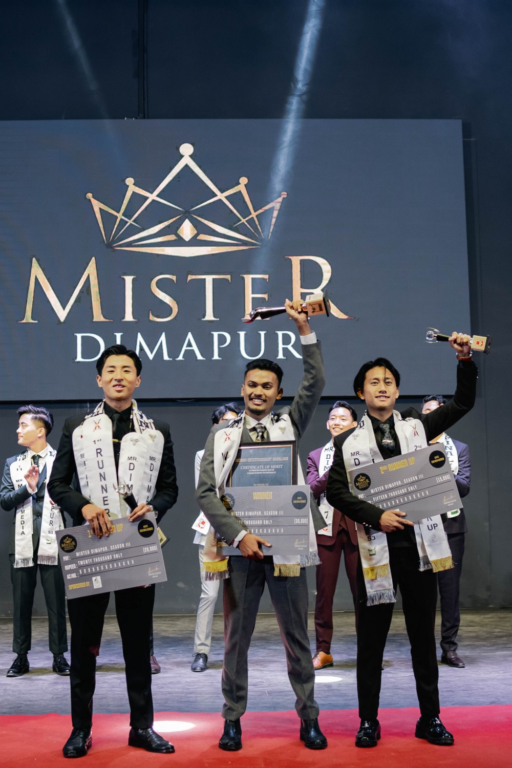 Mr Dimapur 2023, Bikee Dutta (middle) with first and second runner-up titles winners Pongennok and Thushi Jr the during the grand finale of the 3rd Season of Mister Dimapur held at Lorin Hall, Tetso College on April 29.