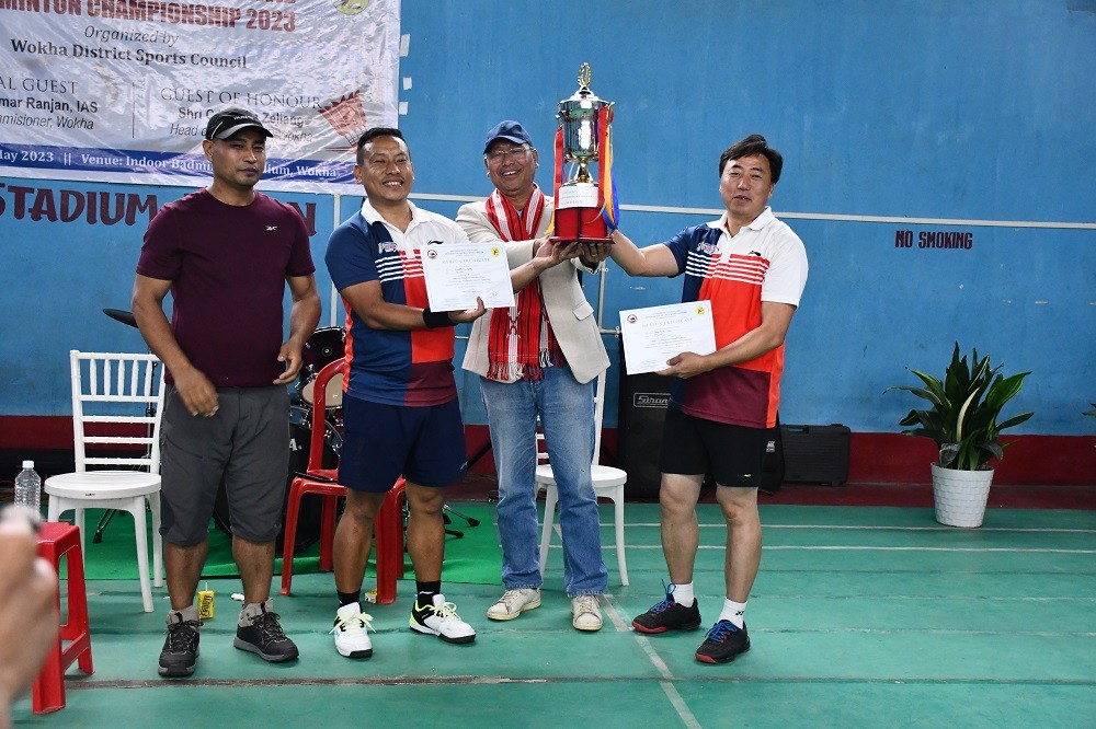 Benathung & Ashonthung of 7th NAP lifting the Men’s doubles championship award from CH John Zeliang, Head of Plan, DHEP.