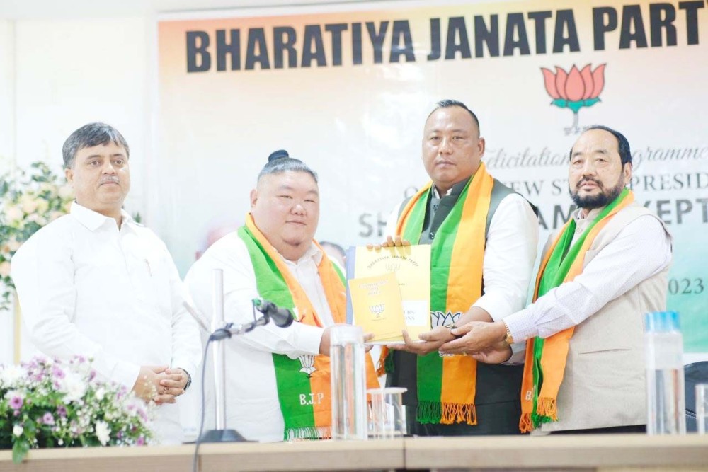 Outgoing president of Nagaland BJP Temjen Imna Along handing over the presidential baton to the incoming president Benjamin Yepthomi during the handing-over-cum felicitation programme held at BJP Headquarters, Kohima on September 28. (Photo Credit @AlongImna/X)