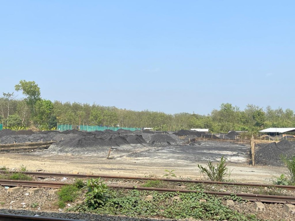 Coals are seen stockpiled for transportation alongside the railway track near Tuli Railway Station in this picture taken March 7, 2023. (Morung File Photo)