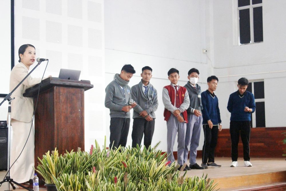 Dr Keduovinuo Keditsu illustrates the harmful components of tobacco by having students list the ingredients found in cigarettes during a tobacco-free campaign at G Rio School, Kohima on October 26. (Morung Photo)