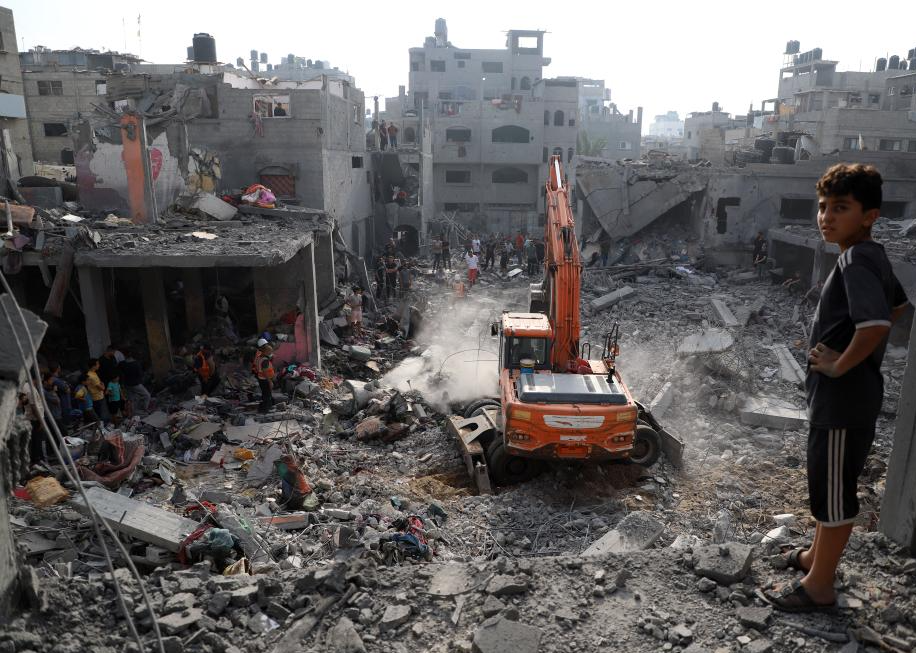 An excavator works on destroyed buildings after Israeli airstrikes in the Southern Gaza Strip city of Khan Younis, Oct. 25, 2023. The death toll of Palestinians from Israeli airstrikes on the Gaza Strip has risen to 6,546, the Hamas-run Health Ministry said on Wednesday. (Photo by Rizek Abdeljawad/Xinhua/IANS)