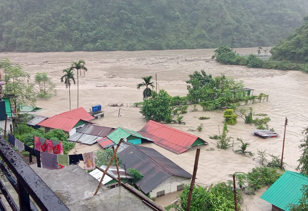 Houses stand half-submerged in the Flooded Teesta River in North Sikkim on October 4. An unexpected cloudburst over Lhonak Lake triggered a swift flood in the Teesta River, affecting Lachen valley. (Photo: IANS)