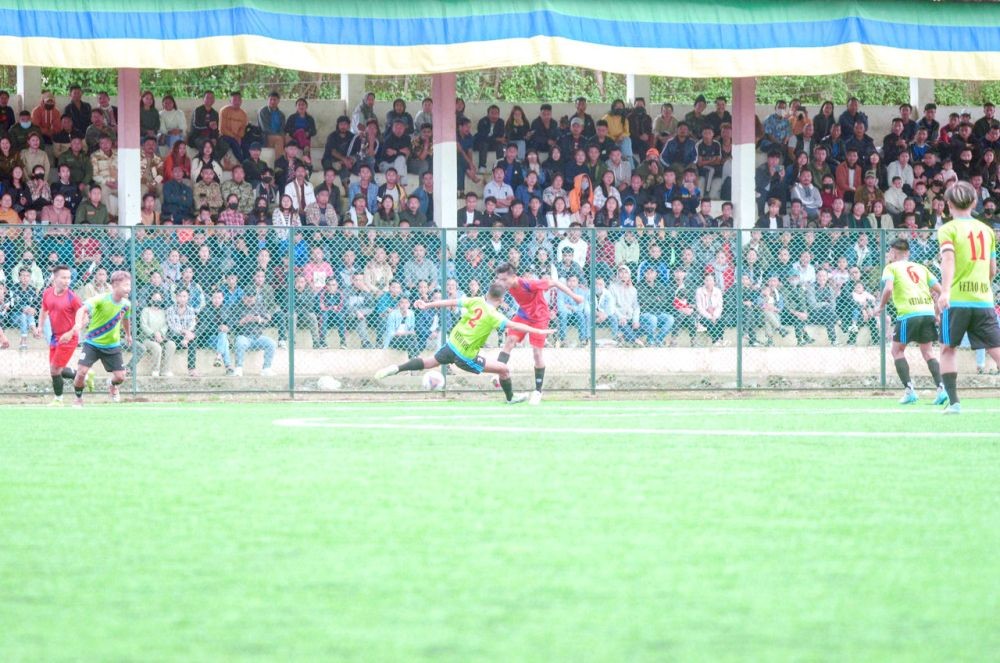 Vetao Ayie FC (neon jersey) and Nyaklangbou Sector Youth Fellowship (red jersey) in action during the semi-final match on October 26.