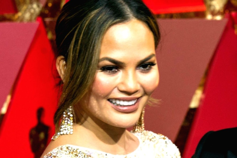 Chrissy Teigen shows off custom leggings featuring images of husband John  Legend on Instagram