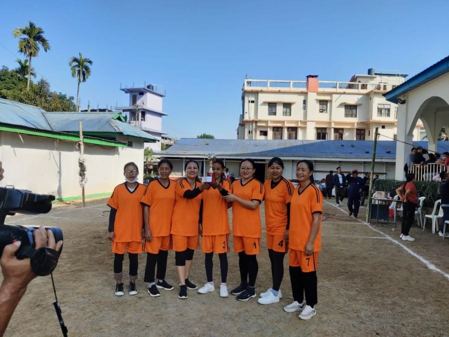 Burma Camp Women's group with the volleyball champion trophy.