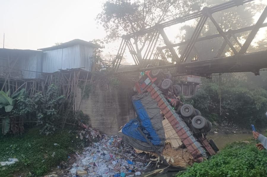 The fallen truck, laden with processed timber, as seen below the Namtola-Mon Bridge on December 15.