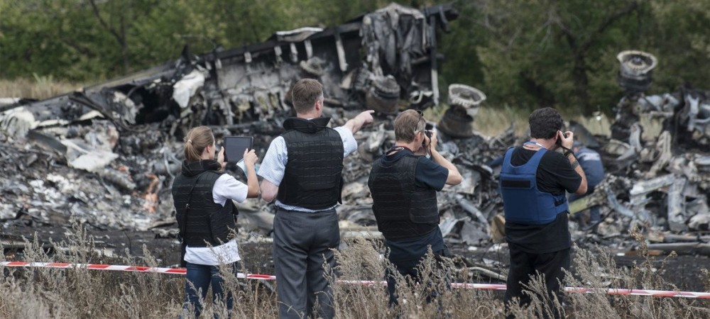 Members of the Organization for Security and Cooperation in Europe (OSCE) Special Monitoring Mission to Ukraine examine the MH17 crash site in July 2014. Photo: OSCE/IANS)