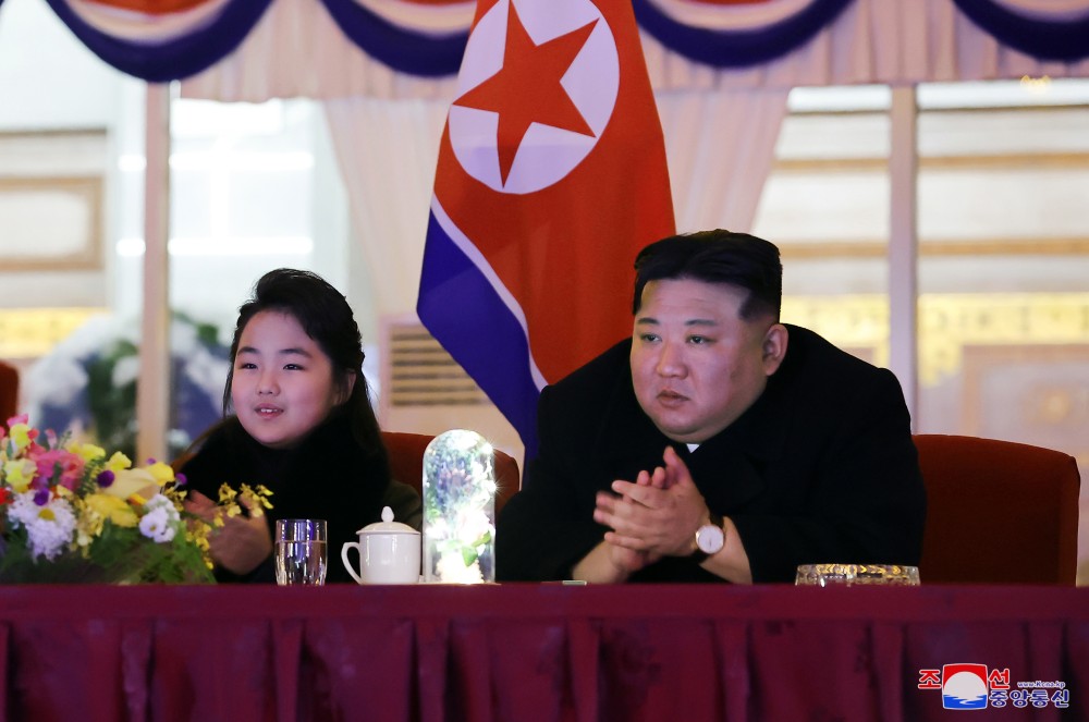 North Korean leader Kim Jong-un (R), alongside his daughter Ju-ae, applauds as he watches an art performance in a New Year's celebration at the May Day Stadium in Pyongyang, in this undated photo released by the North's official Korean Central News Agency on Jan. 1, 2024. (IANS/Yonhap File Photo)