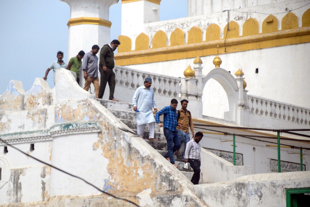 An Archaeological Survey of India (ASI) team inspects Jama Masjid following the High Court's order, measuring the outer walls for painting in Sambhal on Thursday, March 13, 2025. (Photo: IANS)