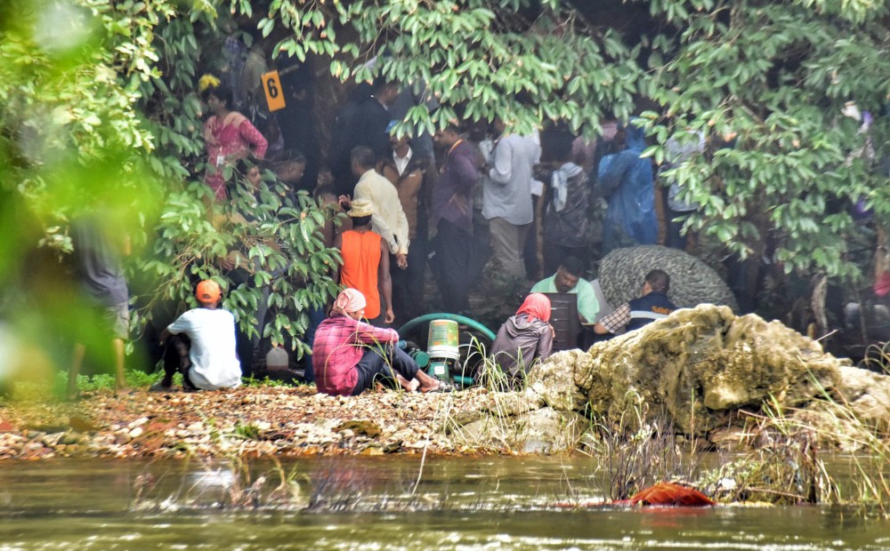 The Special Investigation Team (SIT), probing alleged mass secret burials near the Nethravathi river, recovers partial human skeletal remains from Spot 6 during excavations in Dharmasthala on Thursday, July 31, 2025. (IANS)
